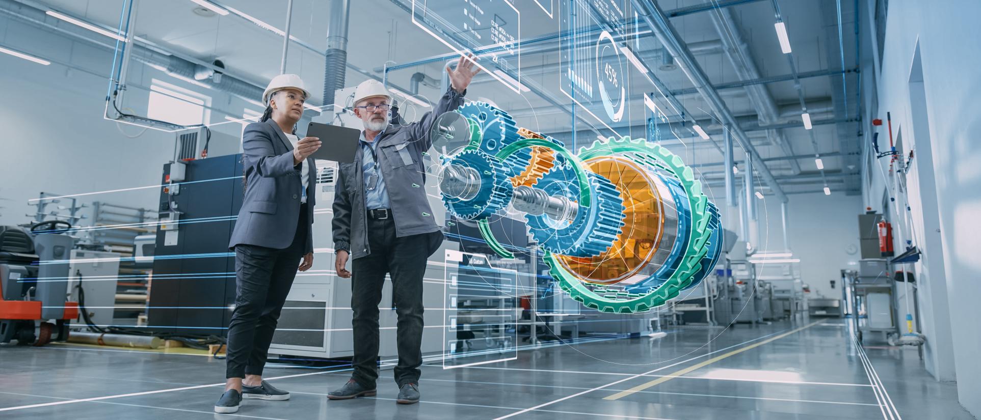 Man gestures his hand up towards a virtual, 3D display of a large, blue, green and orange mechanical cog equipment part. A woman in a navy blue blazer is next to him, holding a tablet, gazing on. Both wear white hard hats. Futuristic displays project all around around them.
