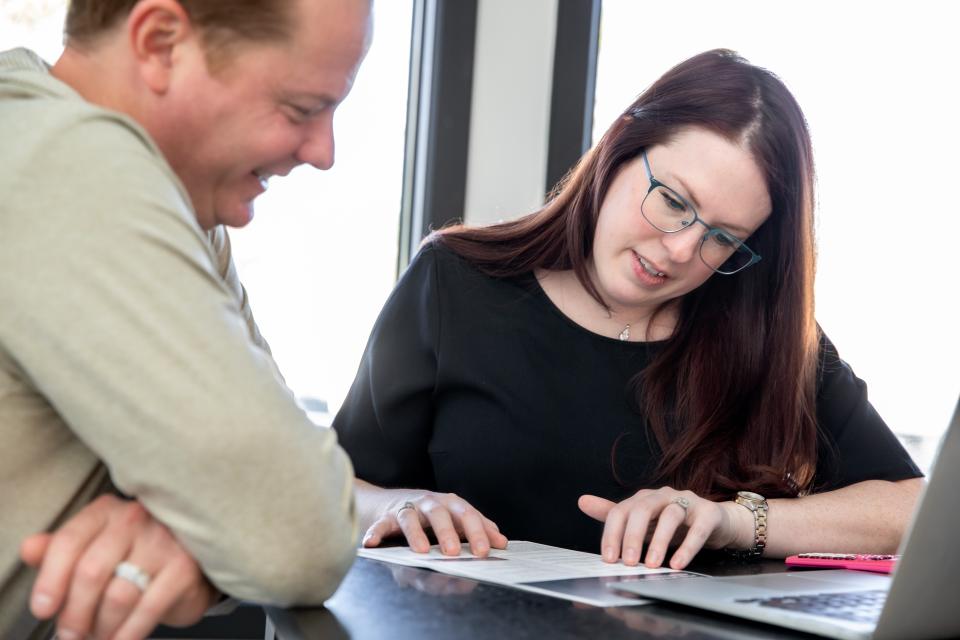 Married couple examining paperwork together.