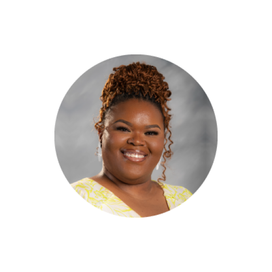 Crystal, a black woman smiling in a yellow shirt.