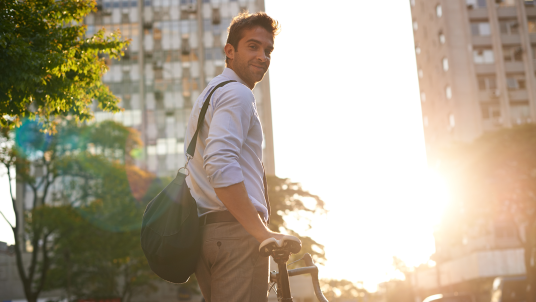 Young professional taking a bicycle to work.