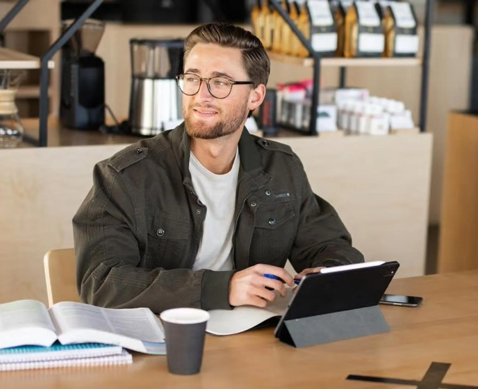 Student studying at a coffee shop on a tablet